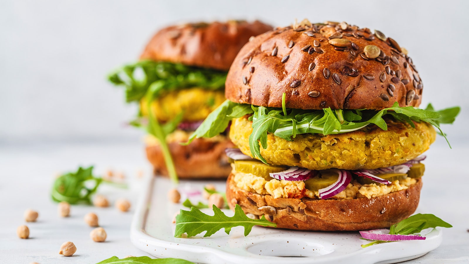 plant based burger with chickpeas, aruglia, pickled cucumber