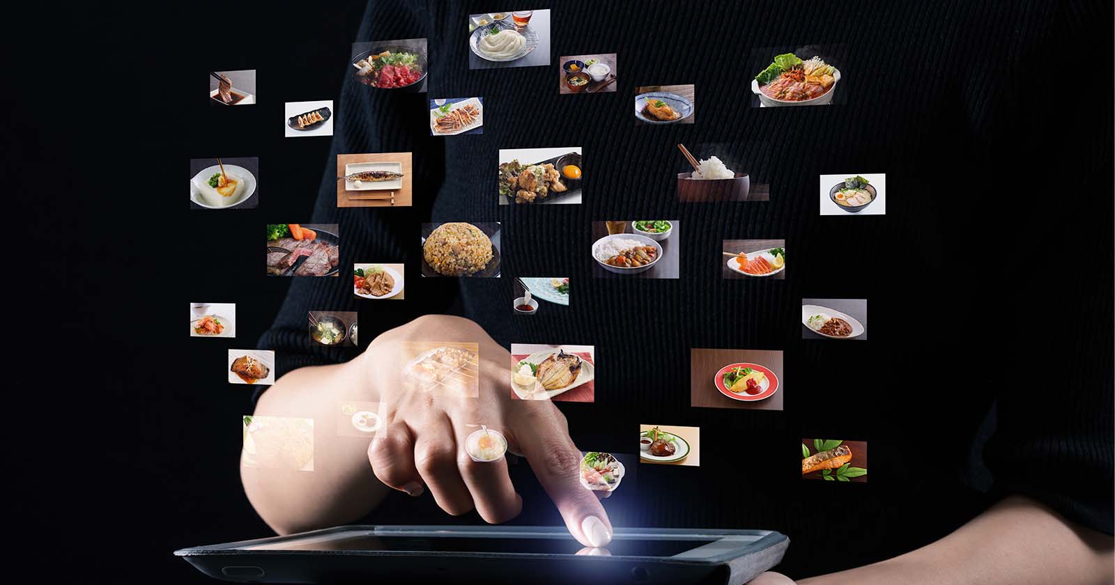 chef tapping on tablet and showing various thumbnails of food