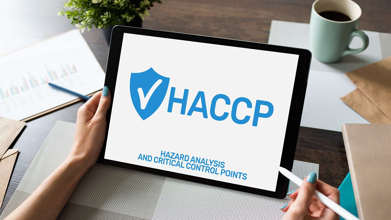 Woman holding a tablet that reads HACCP