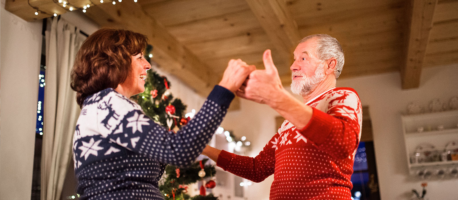 Couple dancing by Christmas tree