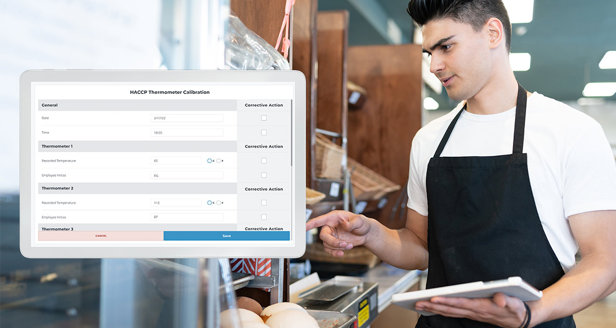 Male server wearing apron checking food inventory