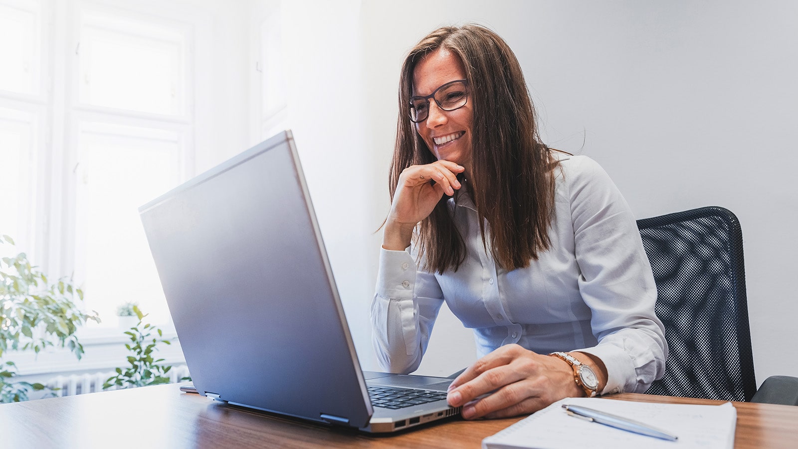 Business woman sitting at her desk working