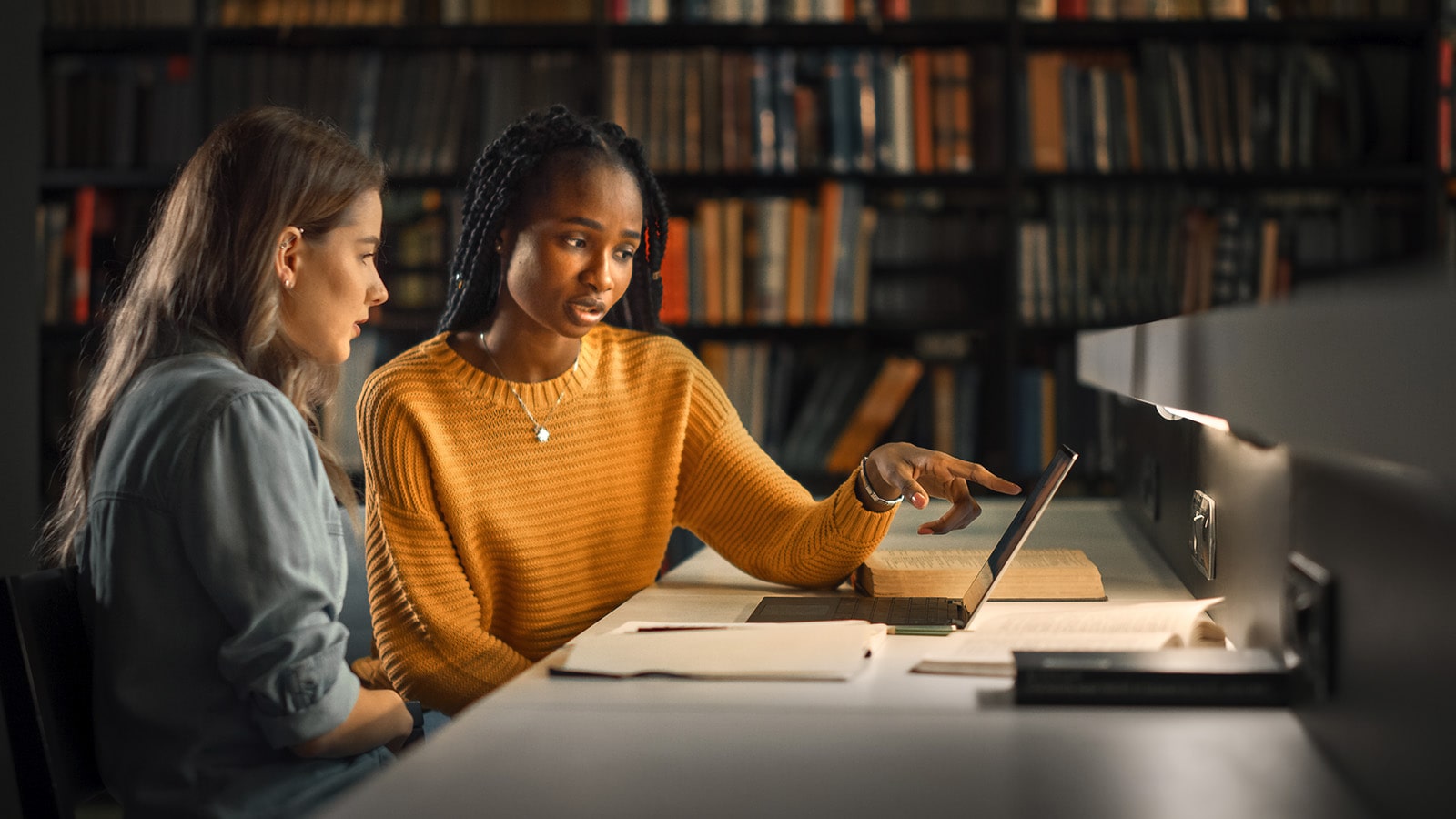 two university students at the library